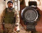 Dar Salim wears a large round digital watch in Guy Ritchie's The Covenant (2023).