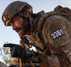 Next to his Casio G-SHOCK on his wrist, Jake Gyllenhaal wears a Garmin 010-01772-10 Foretrex 701 Ballistic Edition in Guy Ritchie's The Covenant.