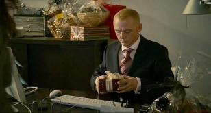 Simon Pegg receiving the gift box containing the Omega watch in How to Lose Frie