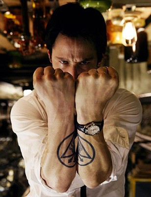 Keanue Reeves showing off his tattoos and Oris Modern Classic in the movie Constantine