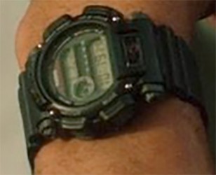 Enlarged close-up of Dwayne Johnson's watch, which seems to be the 1V color variant of the DW9052, but with some red details blacked out with a marker. 