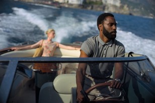 John David Washington wears a Hamilton Jazzmaster Seaview Chrono watch in the movie TENET, seen here driving a speedboat with Elizabeth Debicki in the background